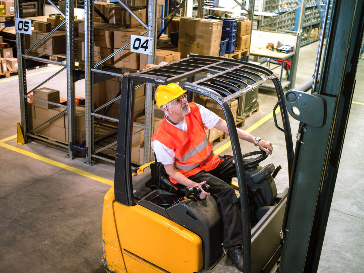 Worker driving a forklift