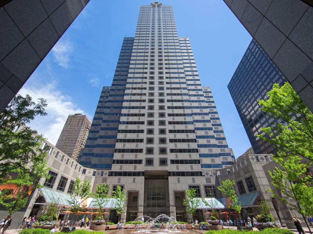 Viewing a tall office building surrounded by blue sky