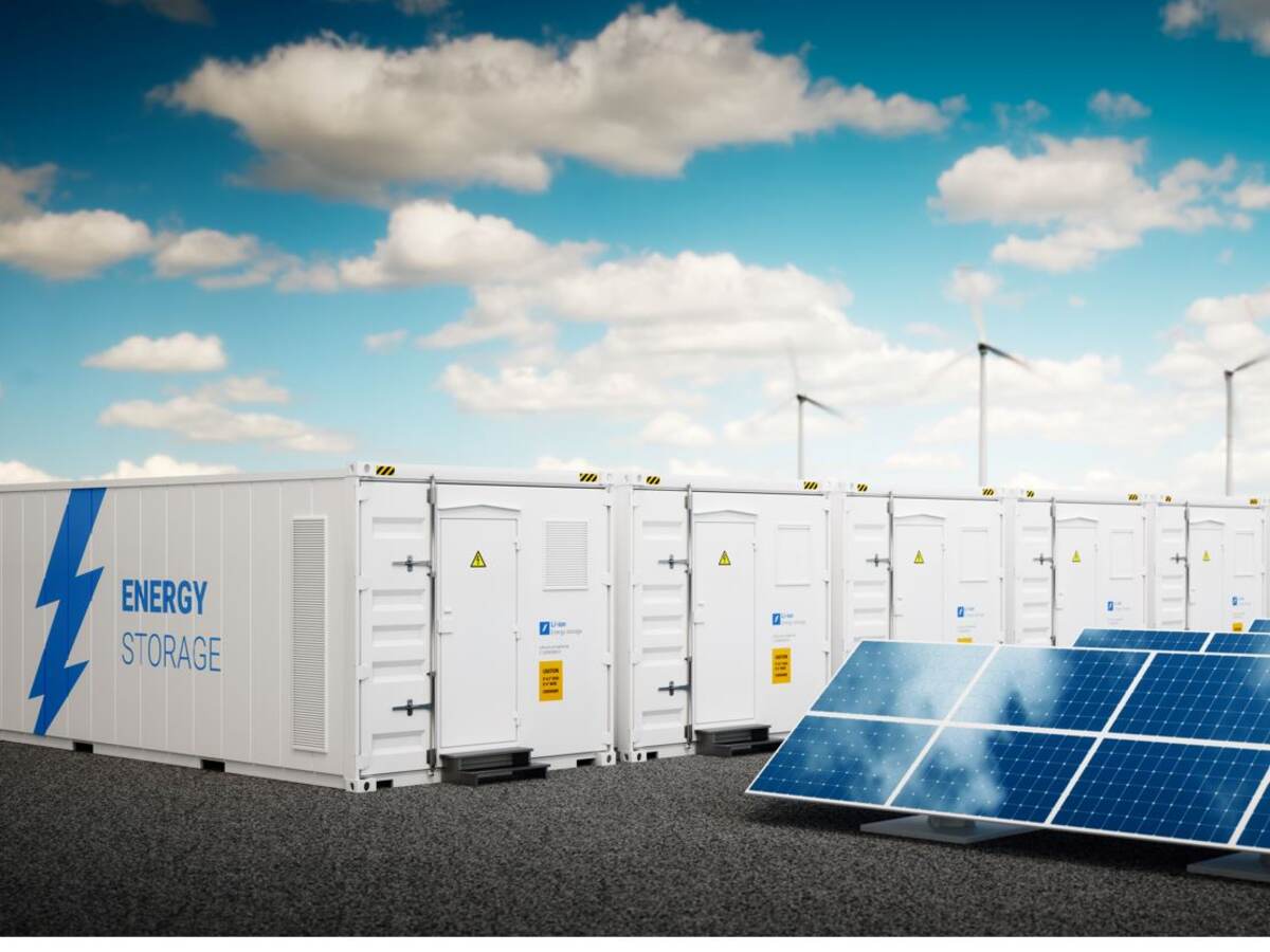 Energy storage cabinets with wind turbines and solar panels with blue sky and light clouds