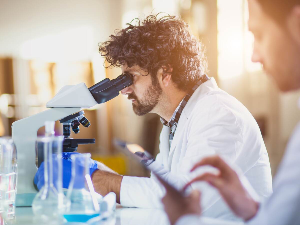 Scientist looking through a microscope