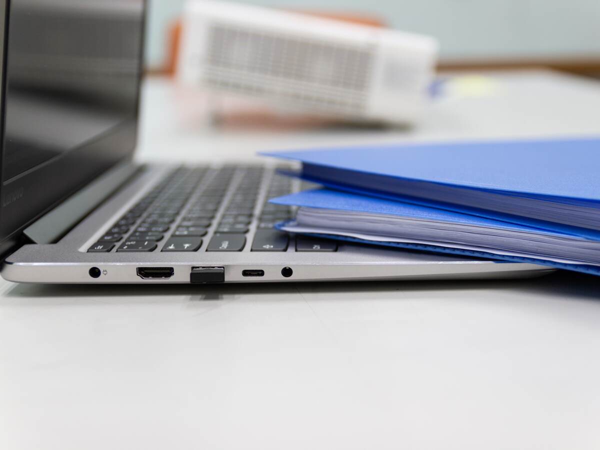 Folders and laptop on a desk.