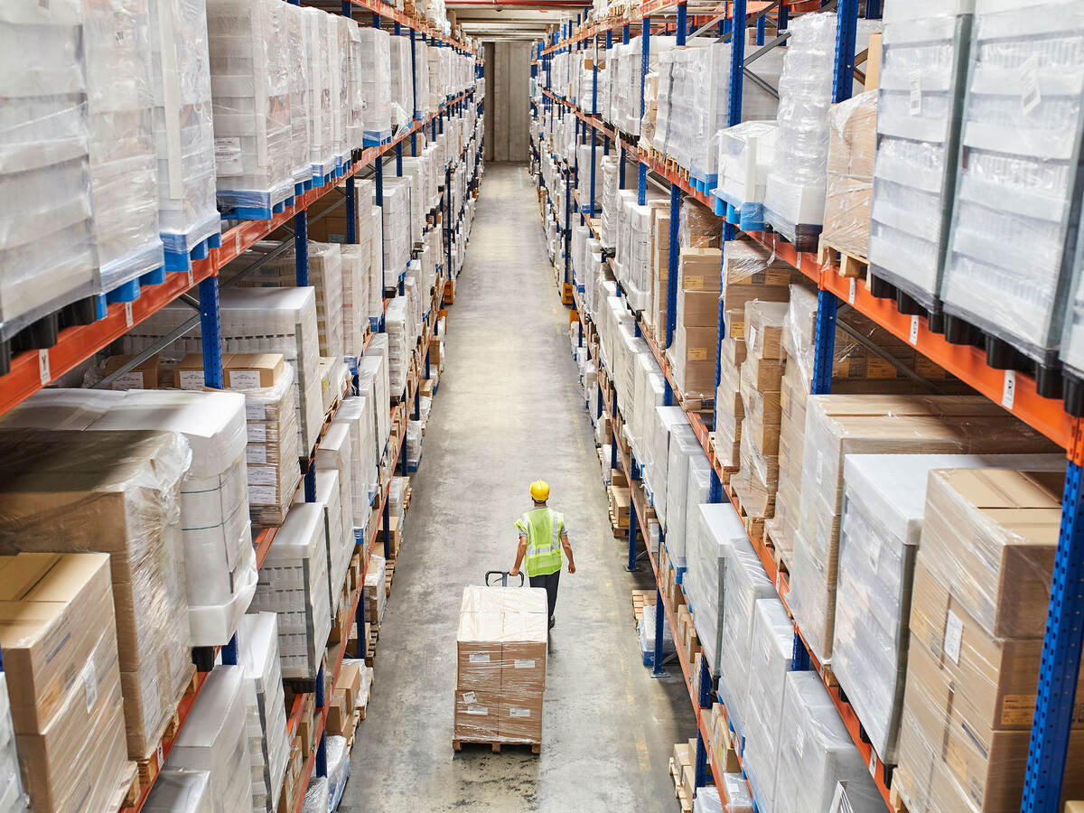 Worker moving a pallet in a warehouse