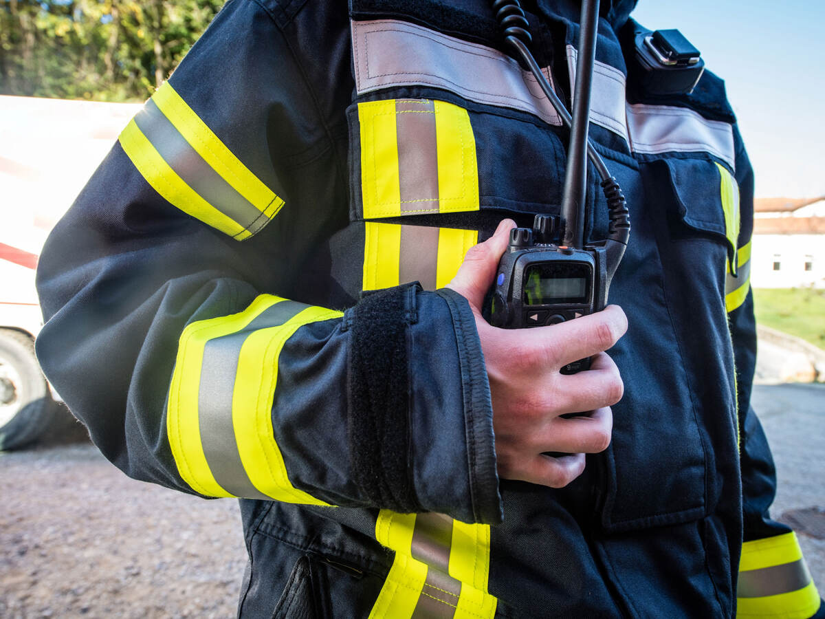 Firefighter using a walkie-talkie during a rescue operation