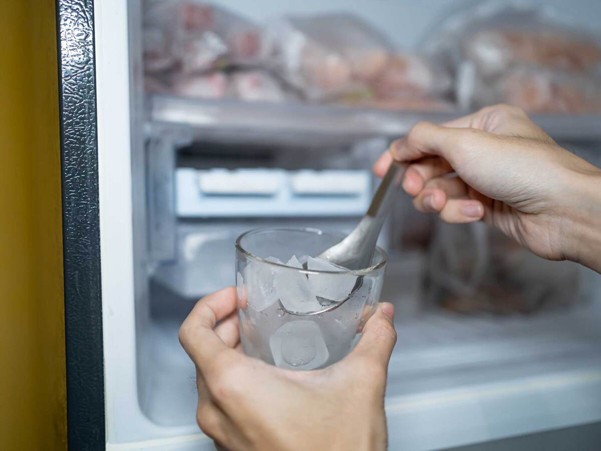 Filling up a glass with ice from freezer