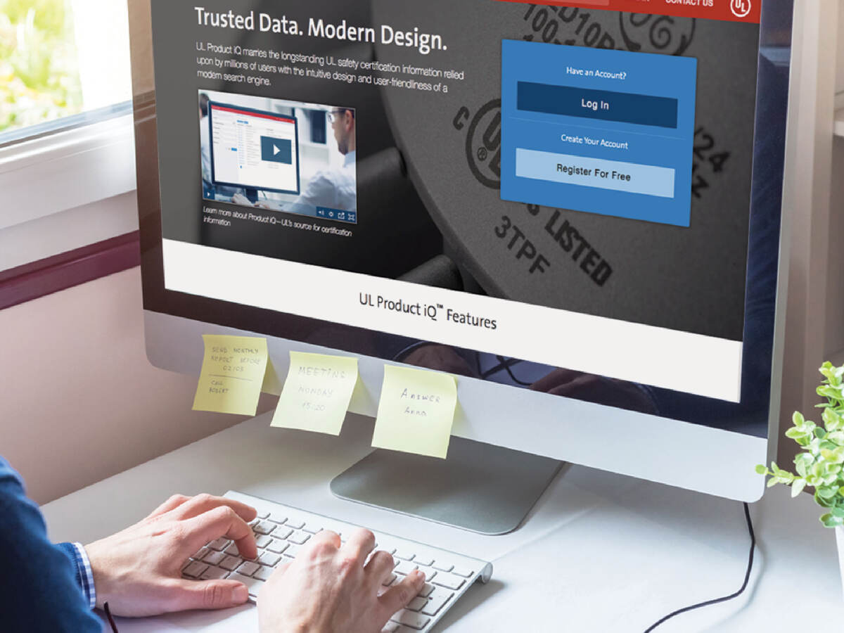 Person sitting at a desk using UL Product iQ on a computer