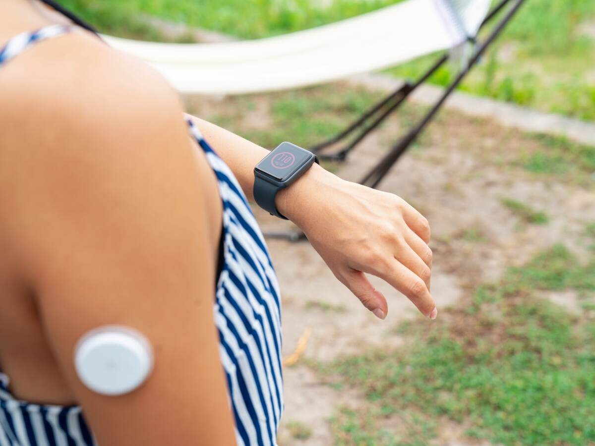 Woman checking a smartwatch to see her blood sugar level