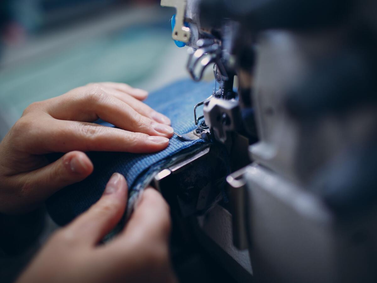 Close-Up Of Hand Holding Fabric.
