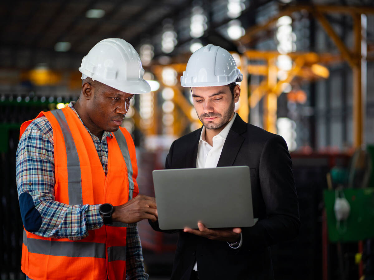 Two engineers looking at a laptop