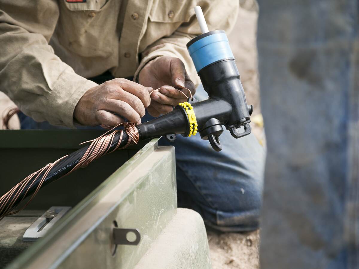 Worker installing medium voltage cable.