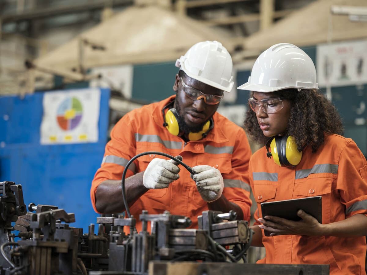 Engineers wearing hard hats and working together