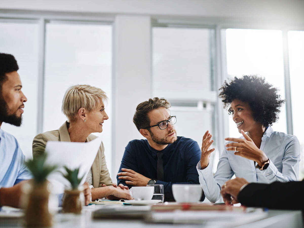 A group of businesspeople sitting together in a meeting.