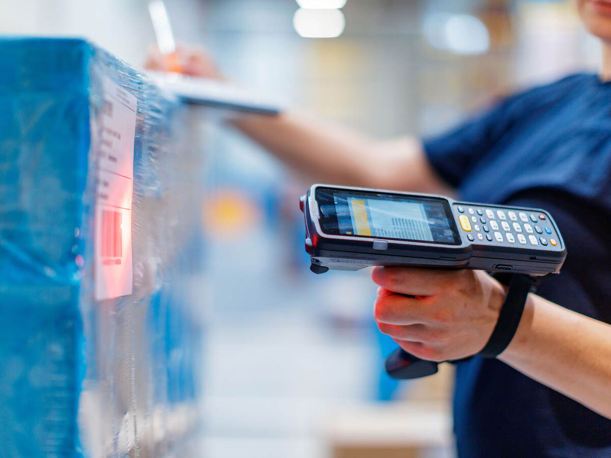 person with barcode reader in warehouse