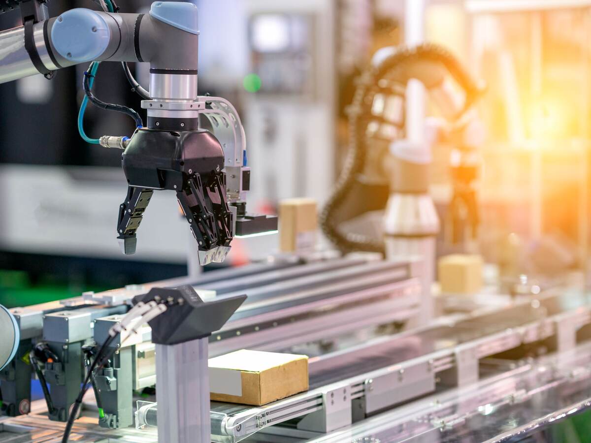 Co-operate robot arm in manufacturing factory concept smart warehouse.