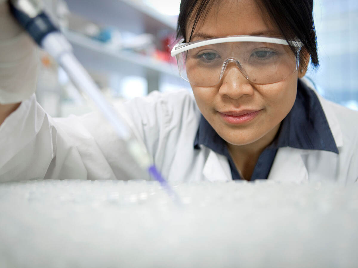 Scientist using a pipette