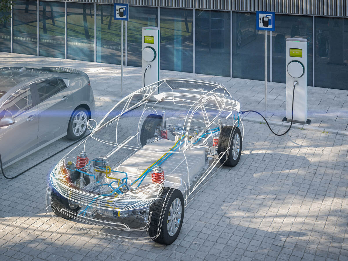 Electric car with battery visible charging at a public charger in city parking lot