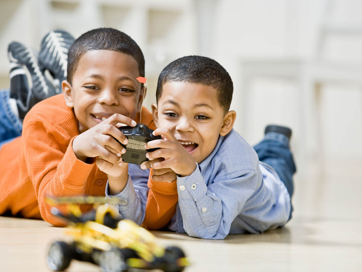 brothers playing with remote control car