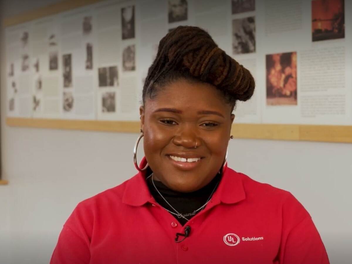 Closeup of Iyana Jolicouer in red collared shirt at UL Solutions. 