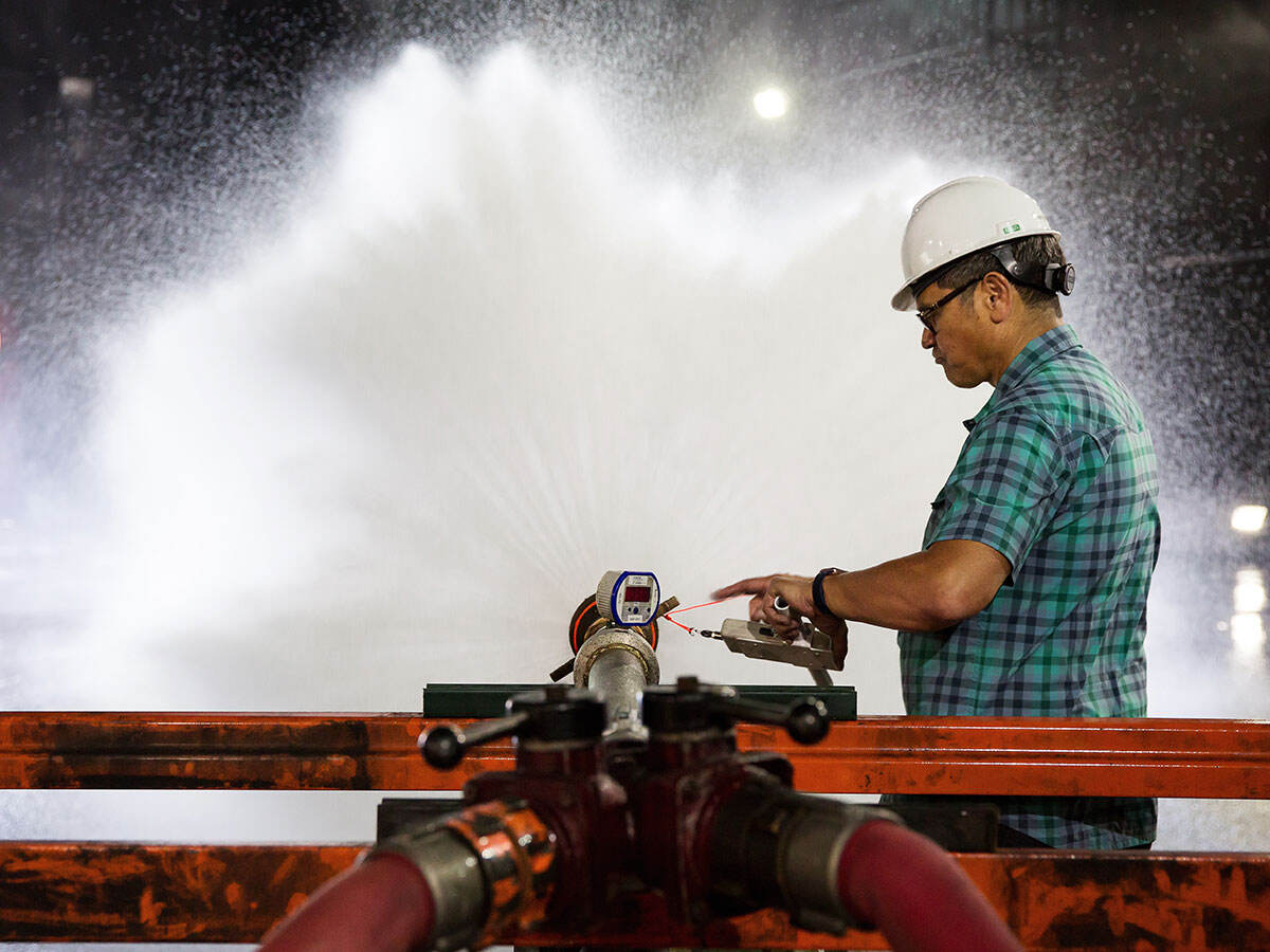 A person conducting fire hose safety testing