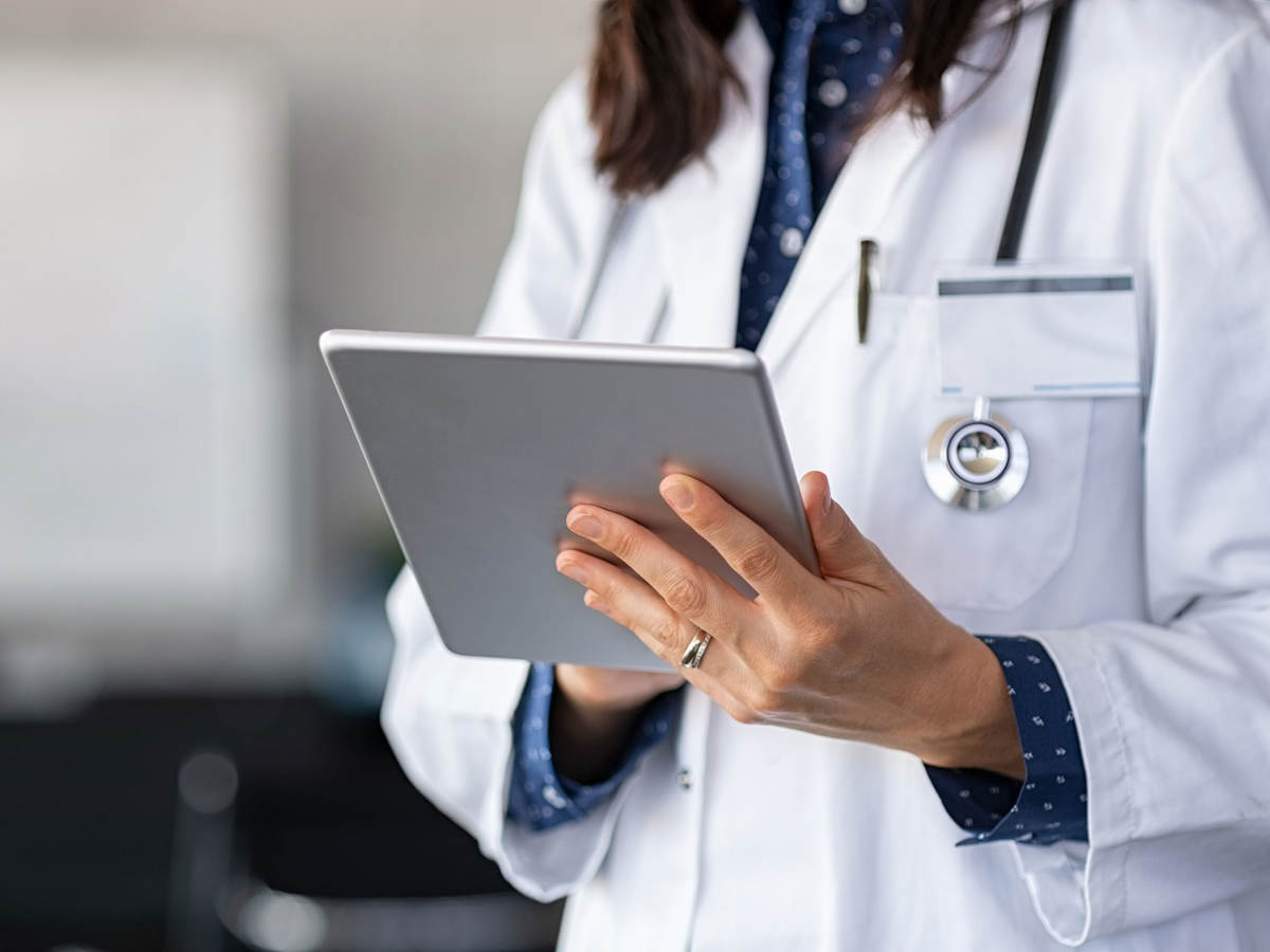 Doctor reading patient reports on a tablet