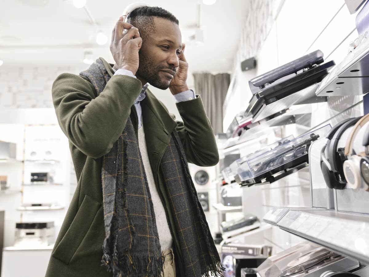 Man trying on headphones in a store.