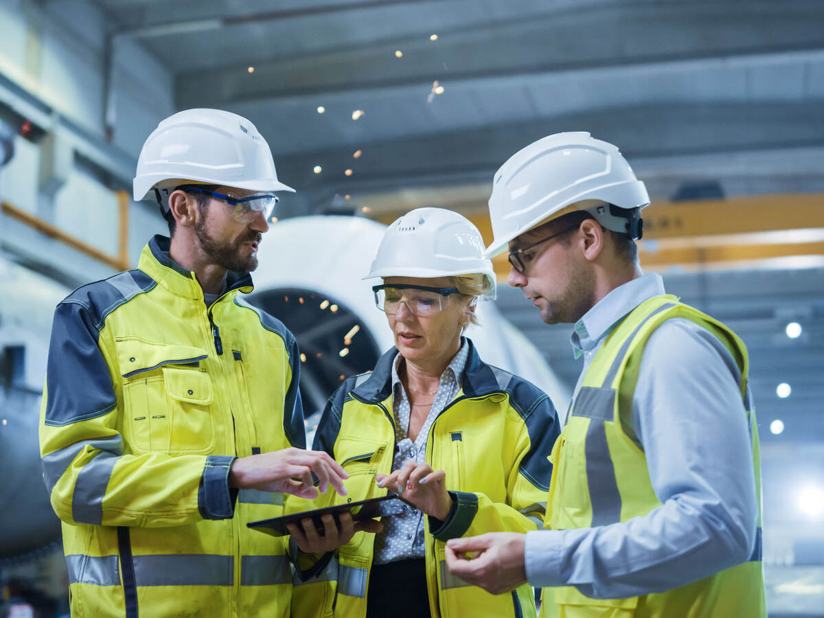 Three engineers discussing a project