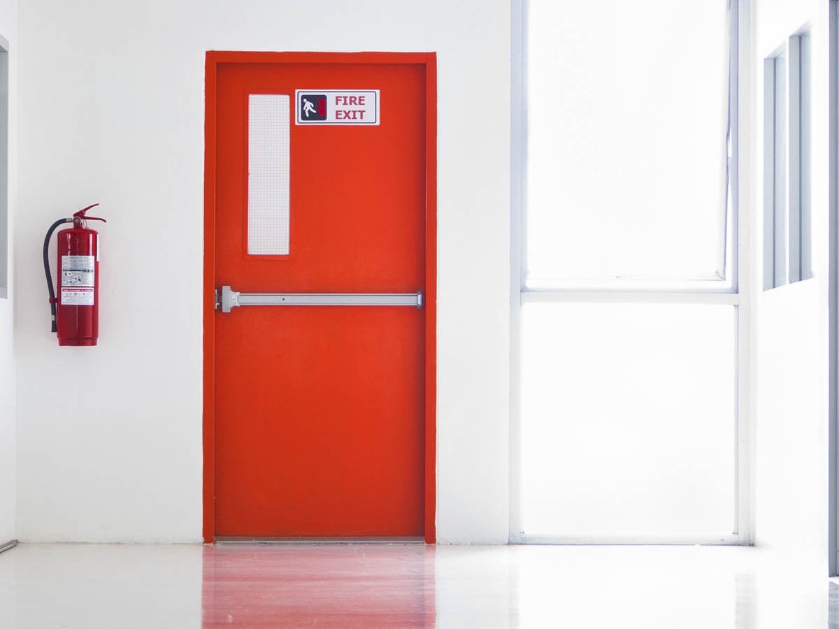 Red emergency fire door with labels