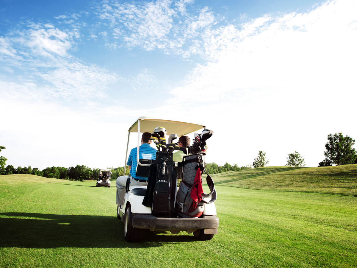 Person driving a golf cart