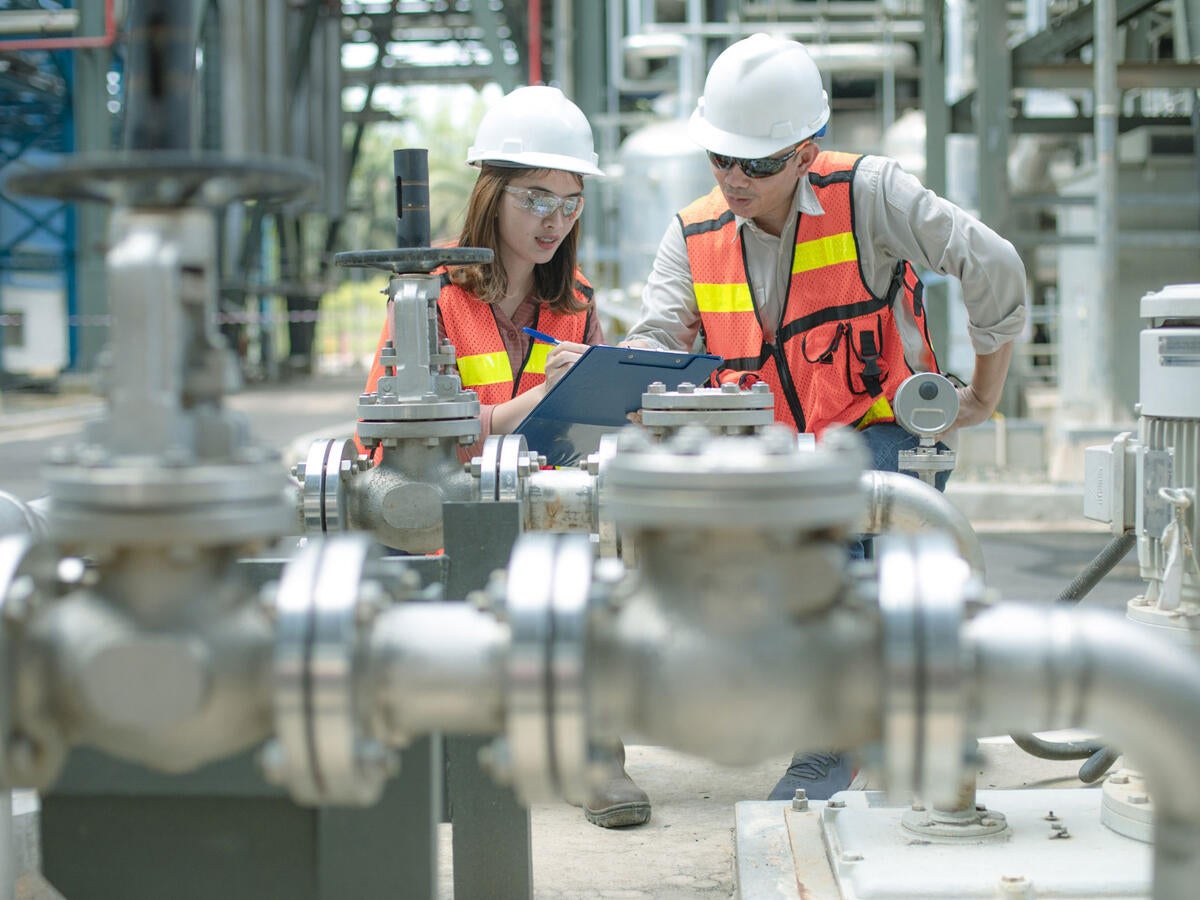 Two engineers inspecting industrial facility