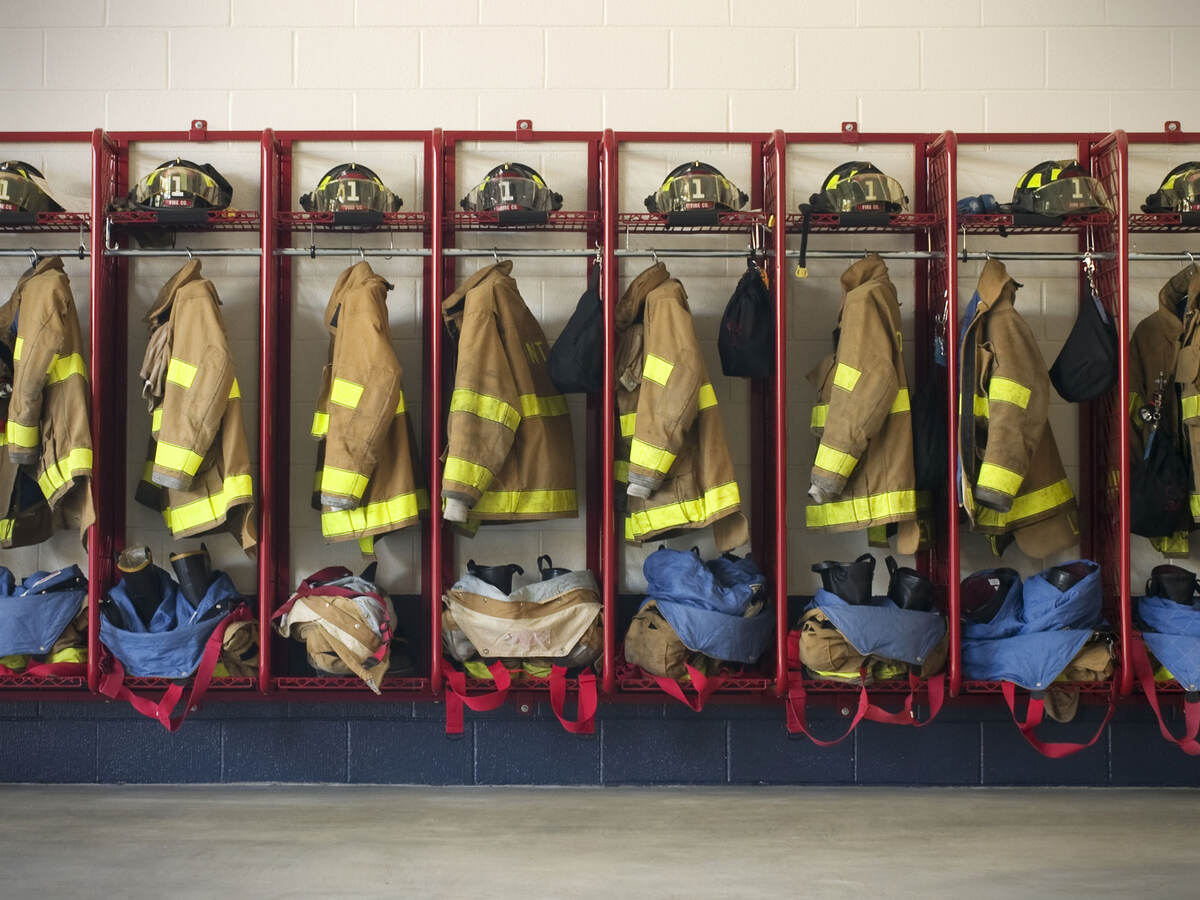 Firefighter suits hung in a row