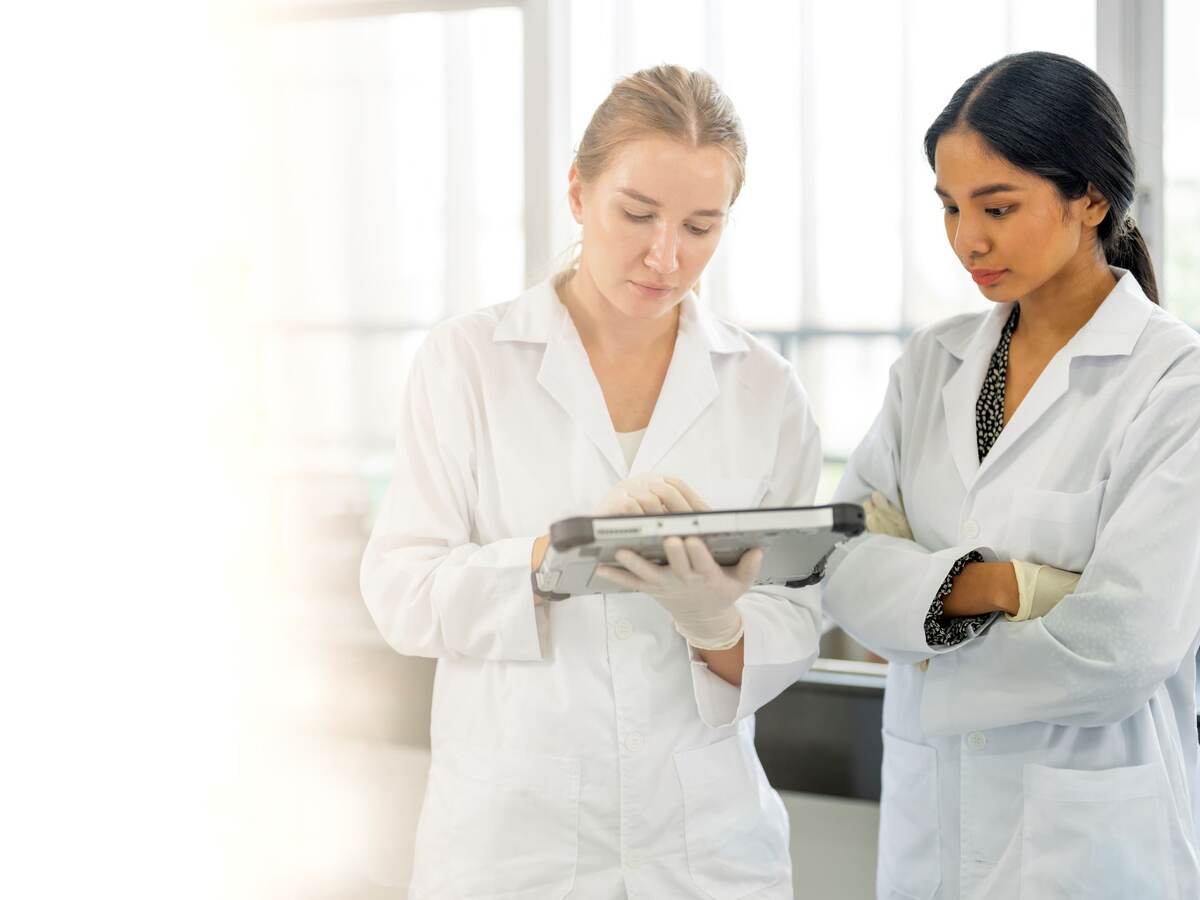 Scientists working in Laboratory having discussion on testing data together.