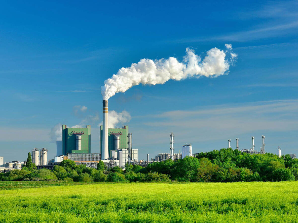 Steaming ignite-fired power plant in a green landscape