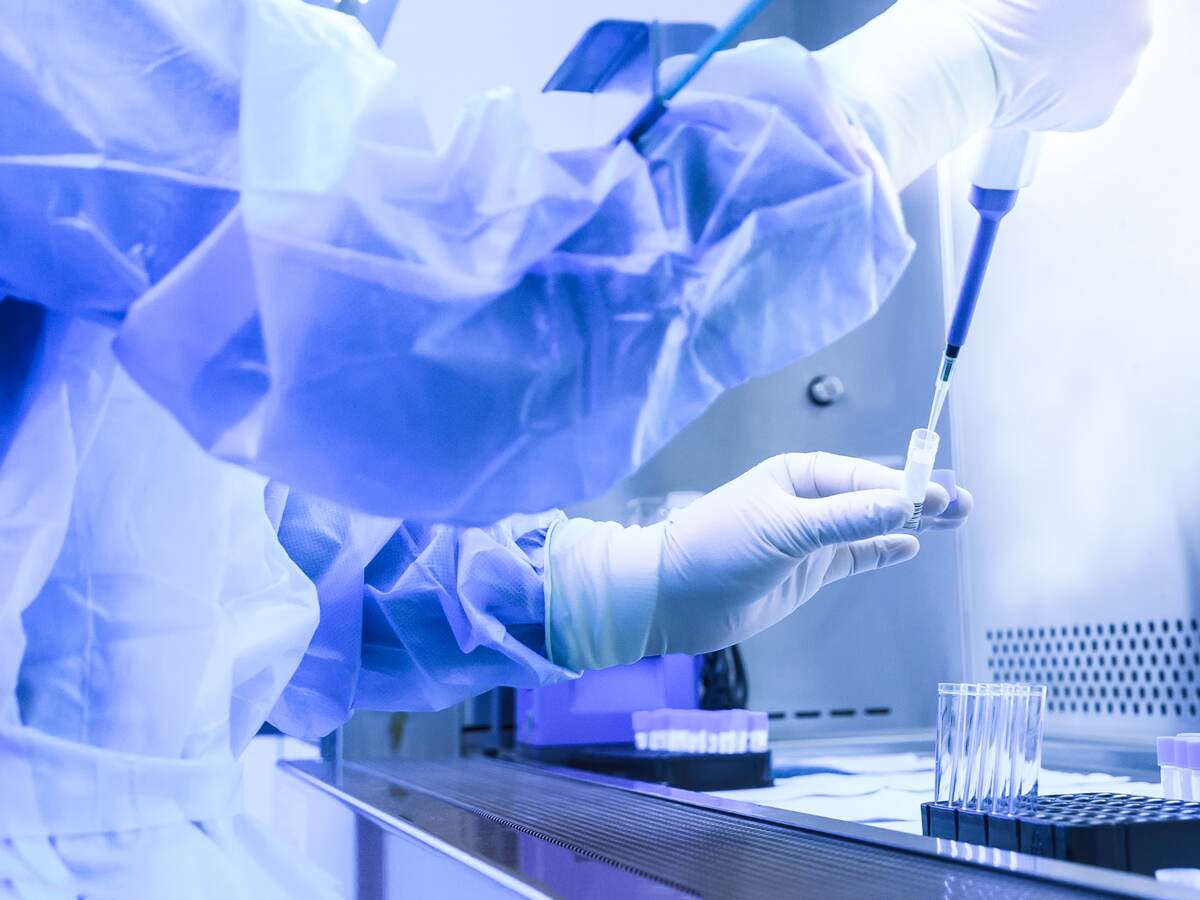 Scientist performing testing in laboratory.