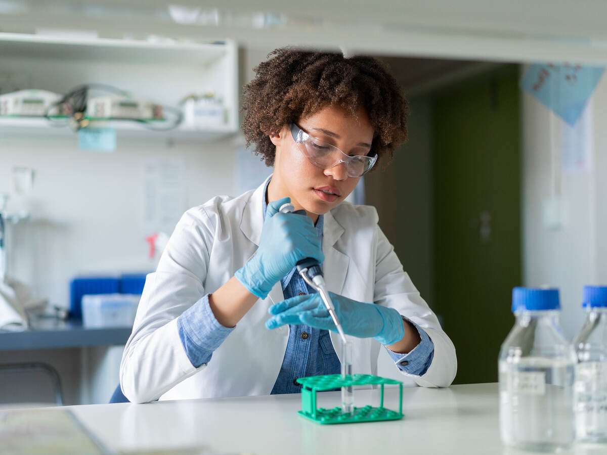 person using a dropper in a laboratory