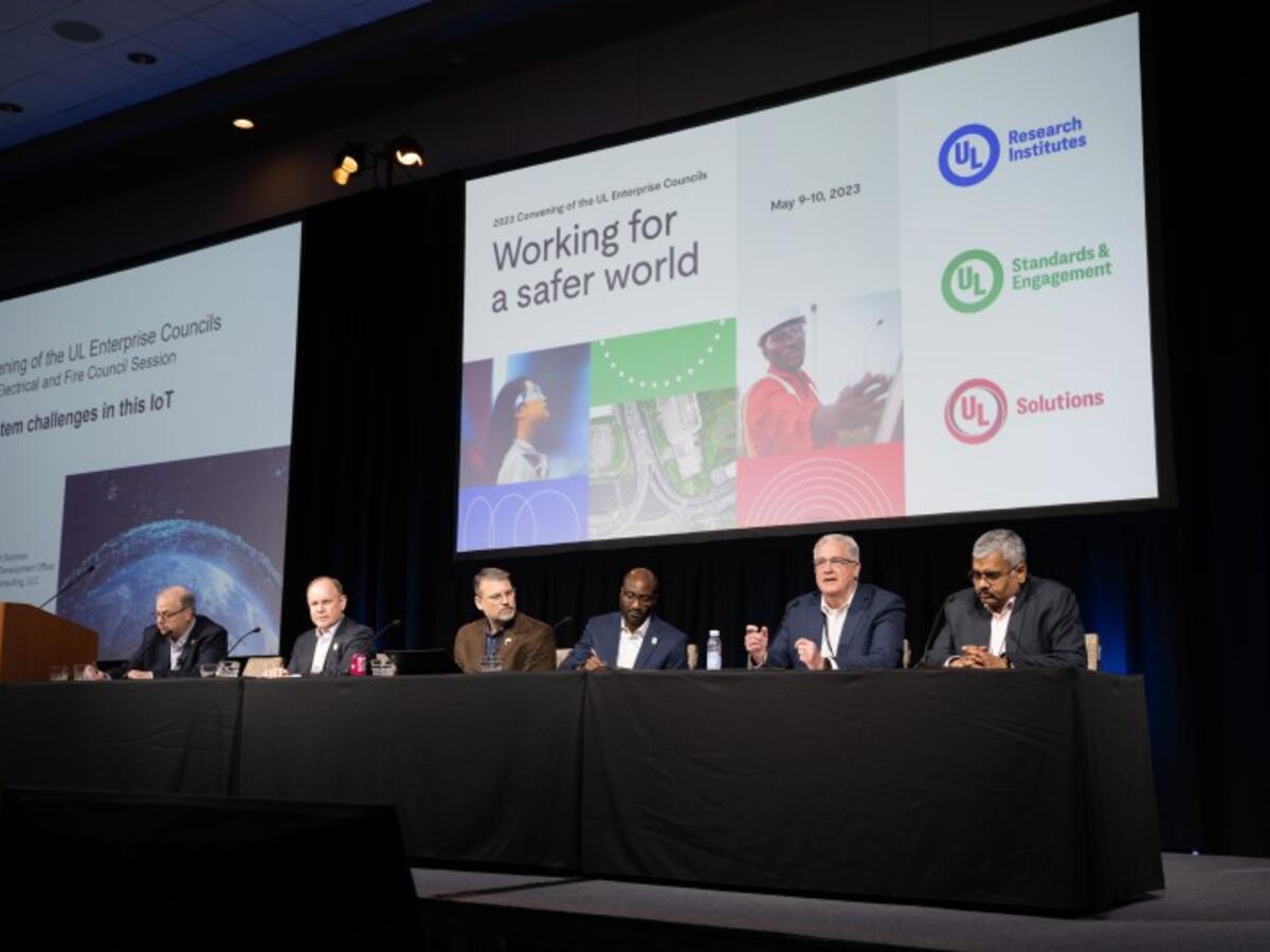 View of panelists sitting at table on main stage.