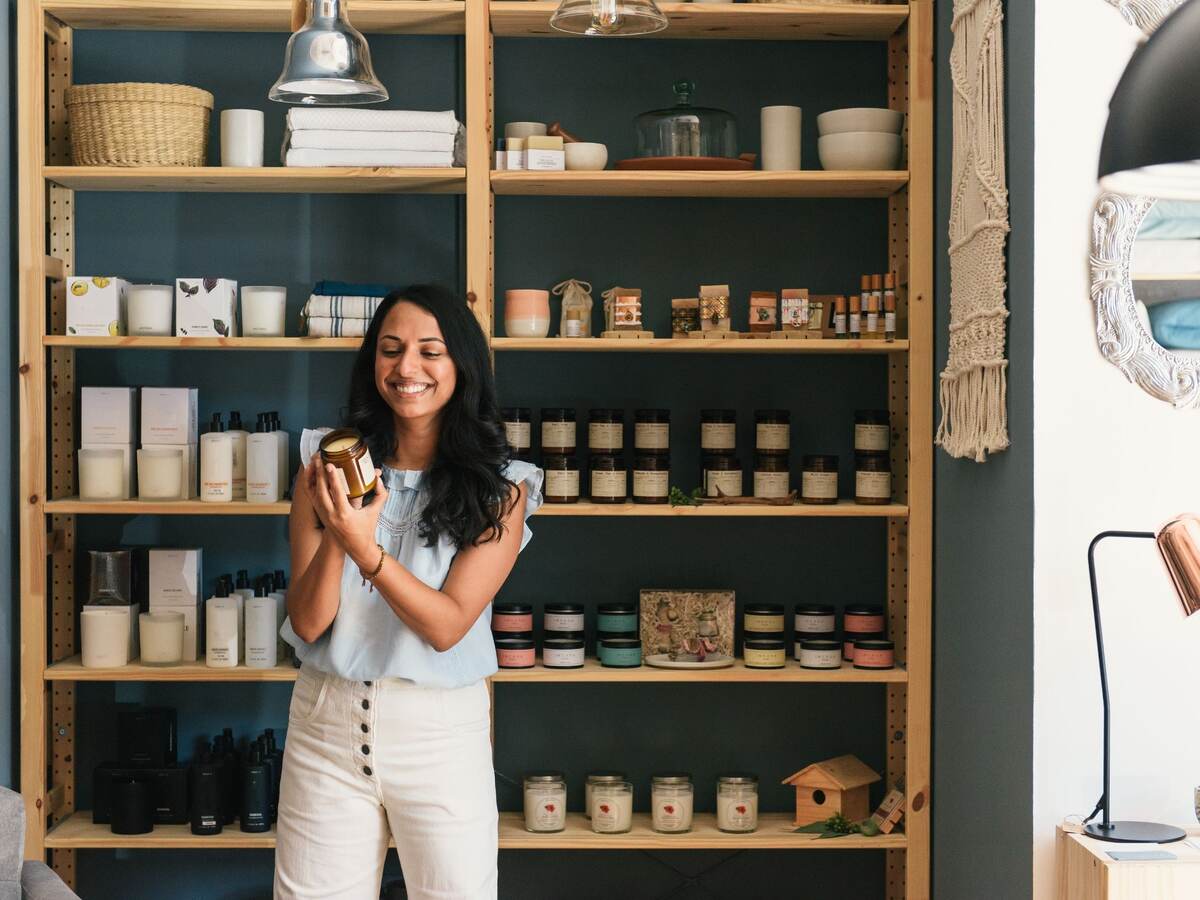 Stylish woman shopping in fragrance and beauty section of home store.