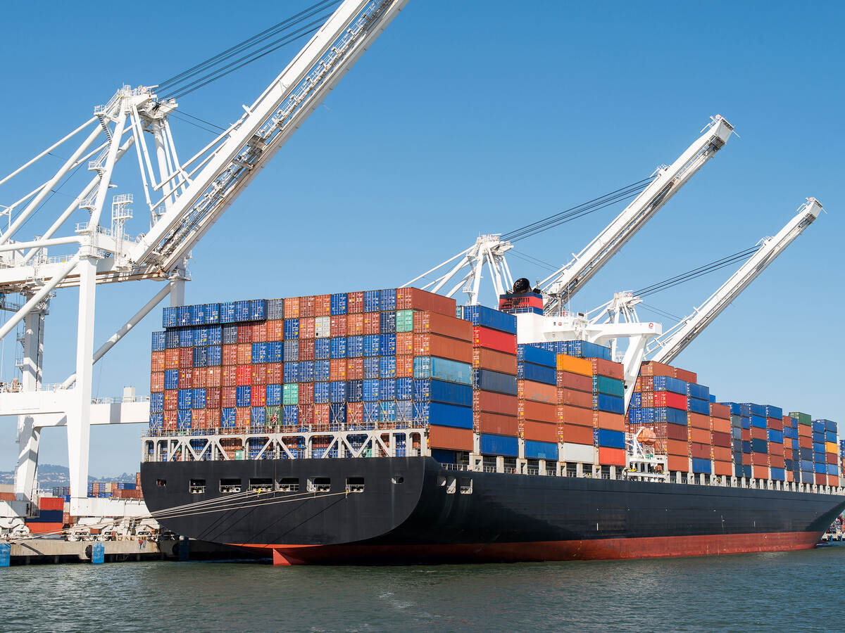 Cargo ship being loaded in harbor