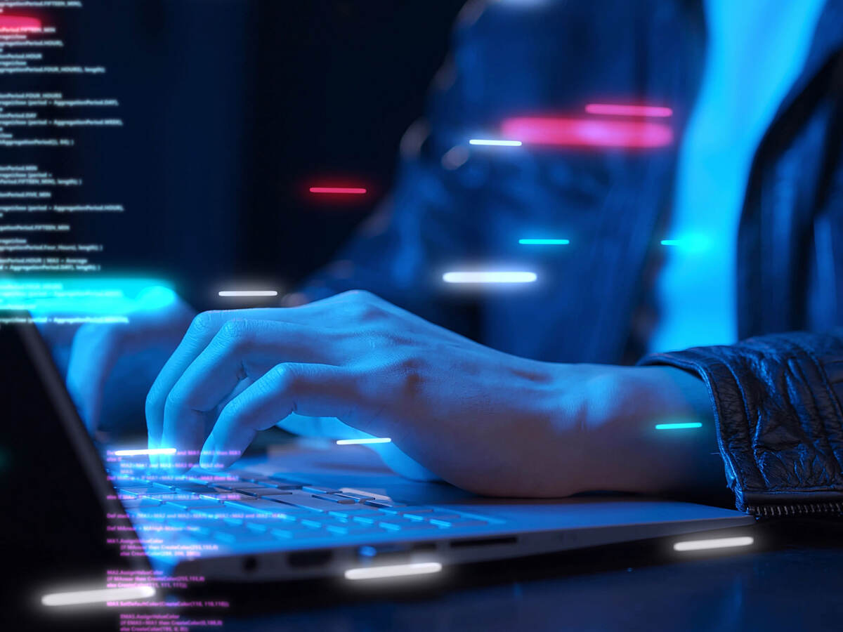 Closeup of a hand typing on a laptop keyboard