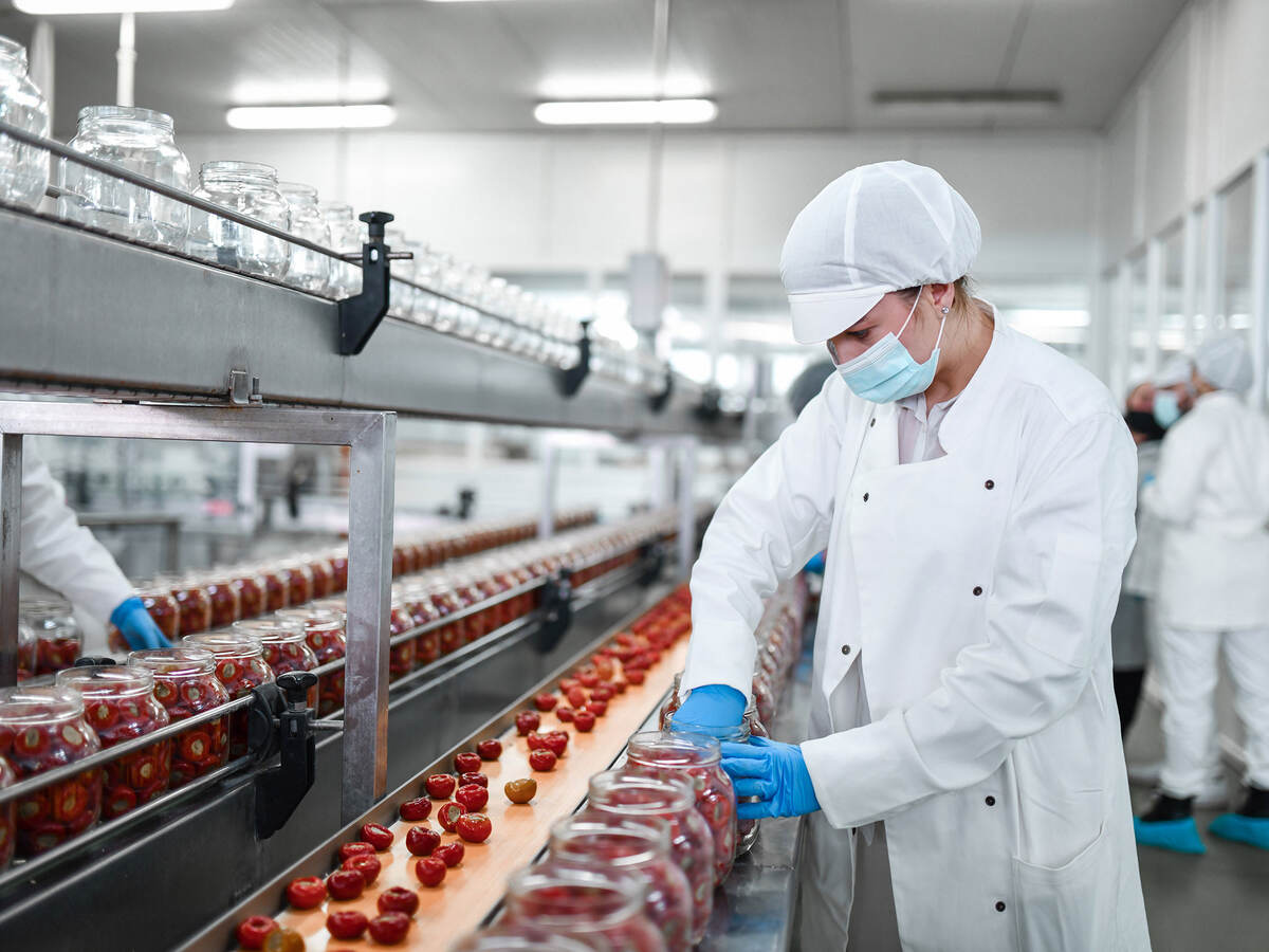 Person working with food on a production line