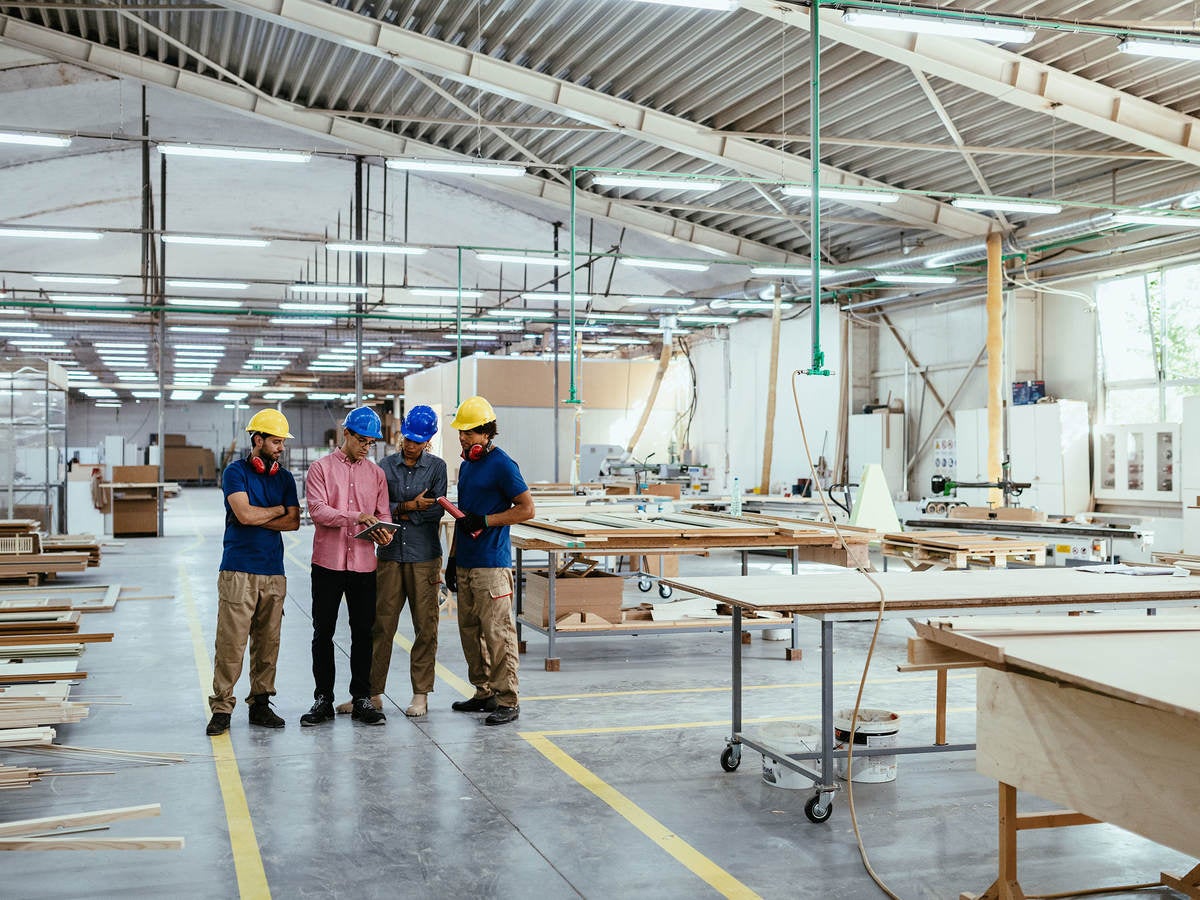 Engineers discussing in modern factory.