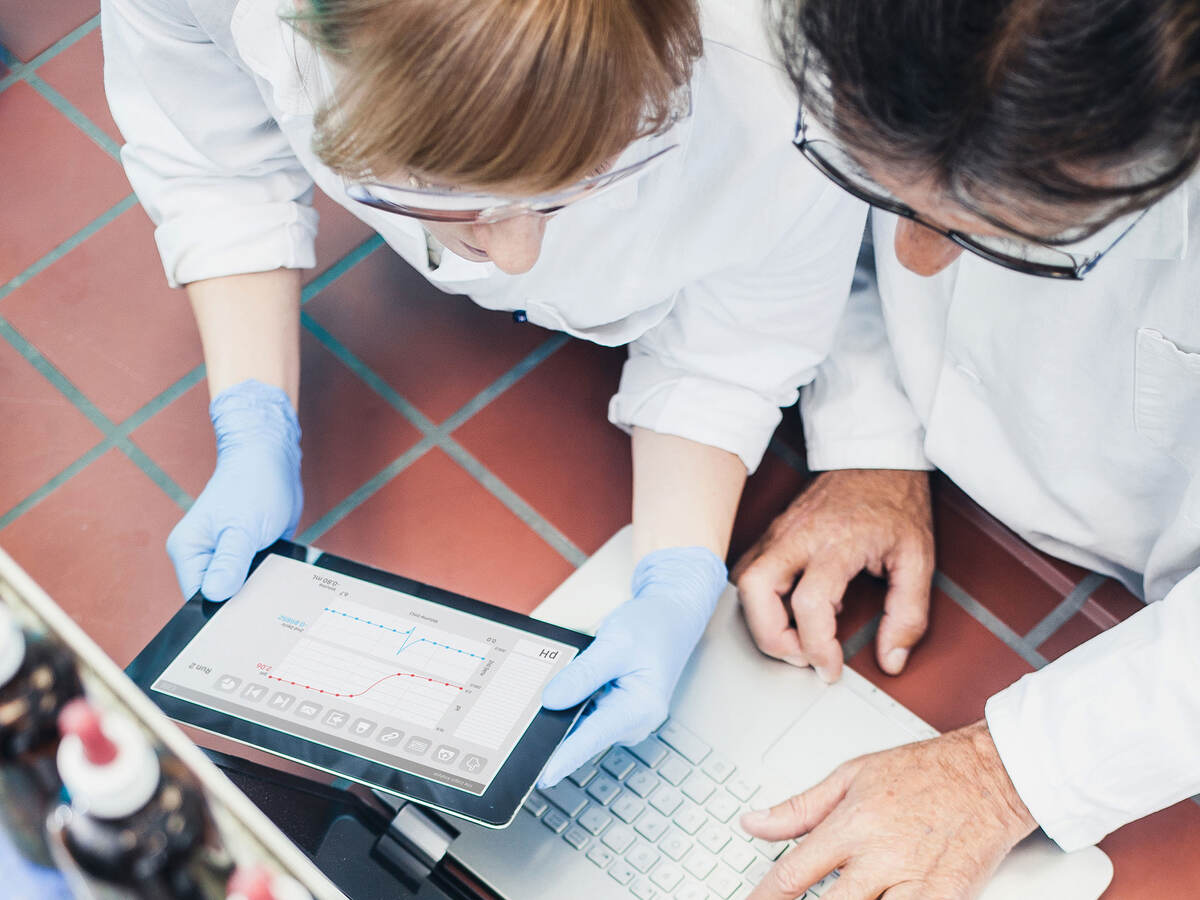 Overhead view of two people working in a laboratory setting