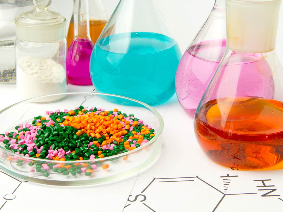 Plastic raw material in granules against the background of Chemical Laboratory and reagents. Polypropylene, Ethylene, Polypropylene research in laboratory conditions