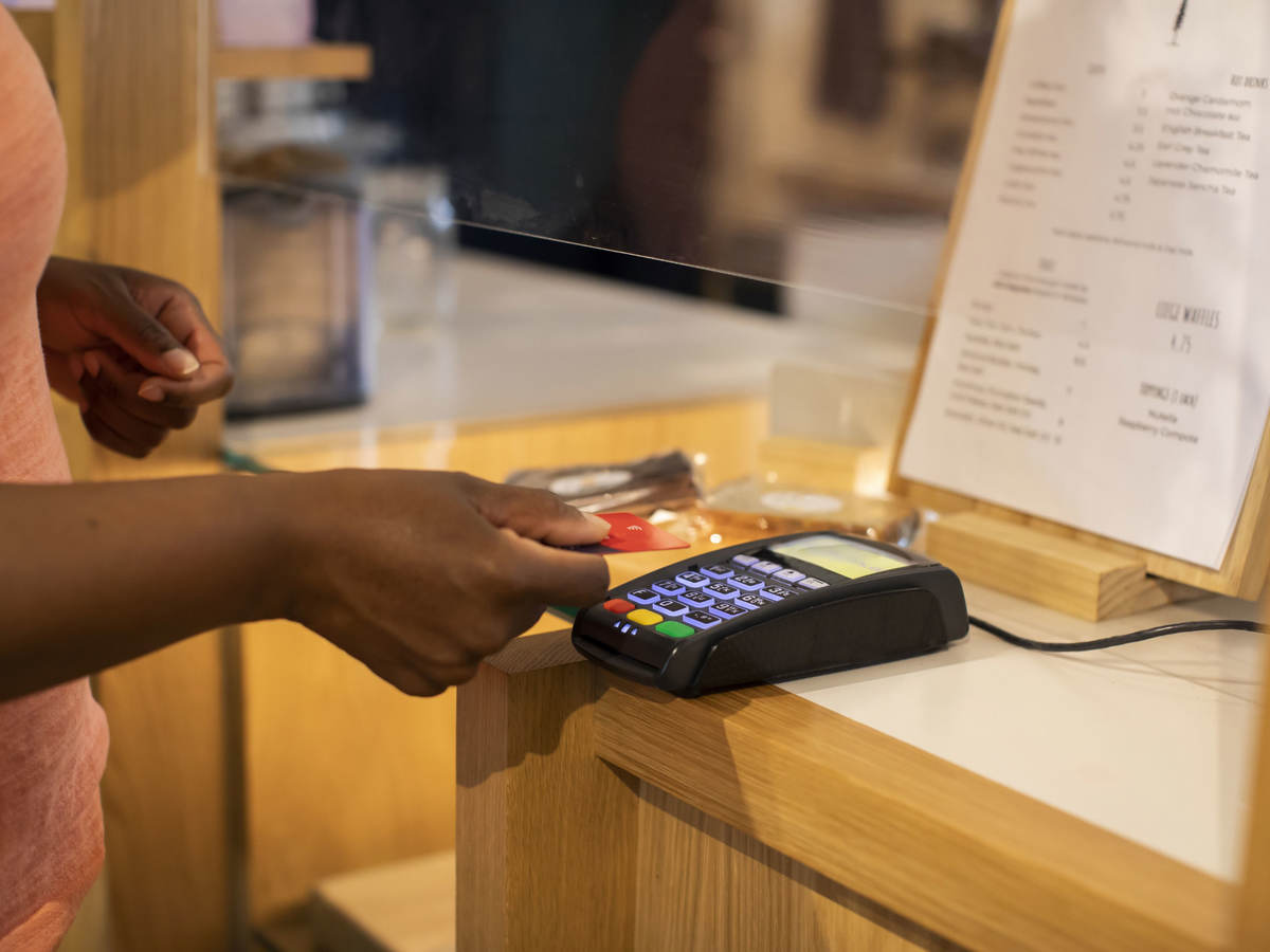 A person making a contactless credit card payment