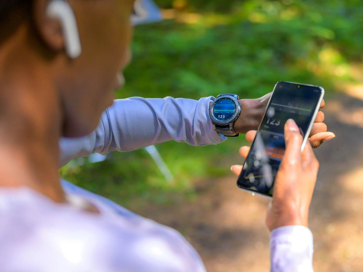 A person using tracker software and a smart watch