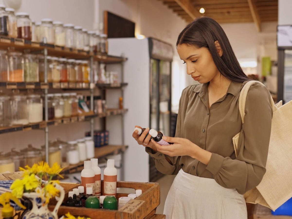 Person reading a label on a product while shopping in a store