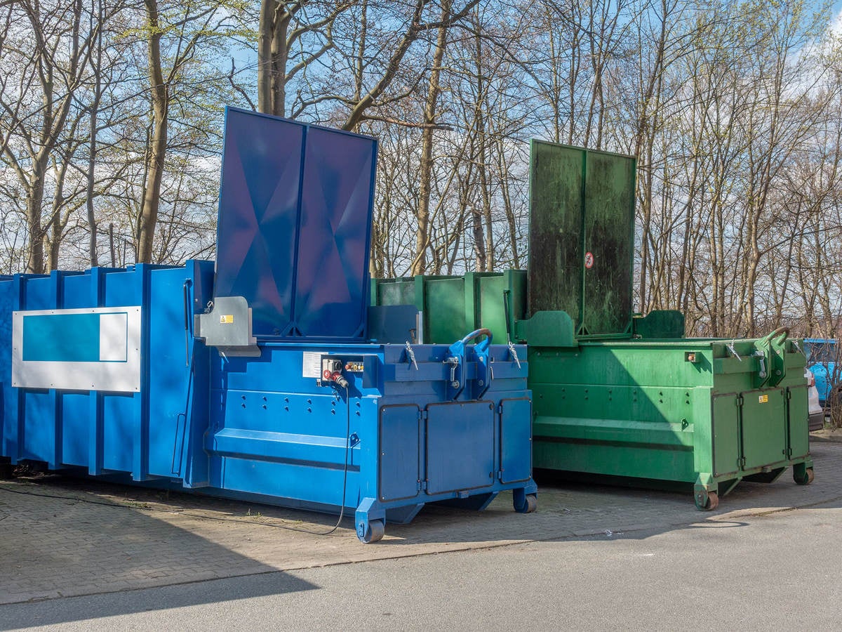 Two large garbage compactors.