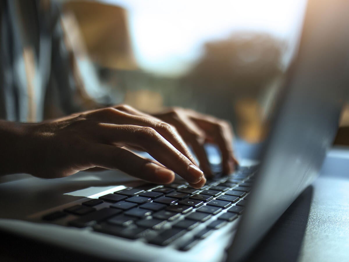 A person typing on a laptop