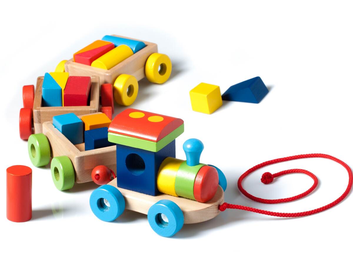 Wooden toy train on white.