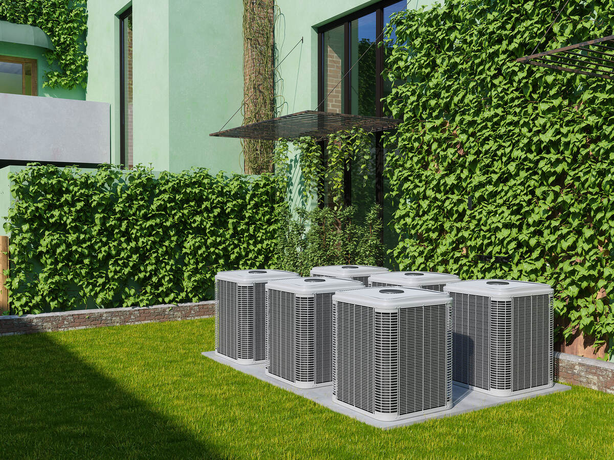Six outdoor air conditioning units in the backyard