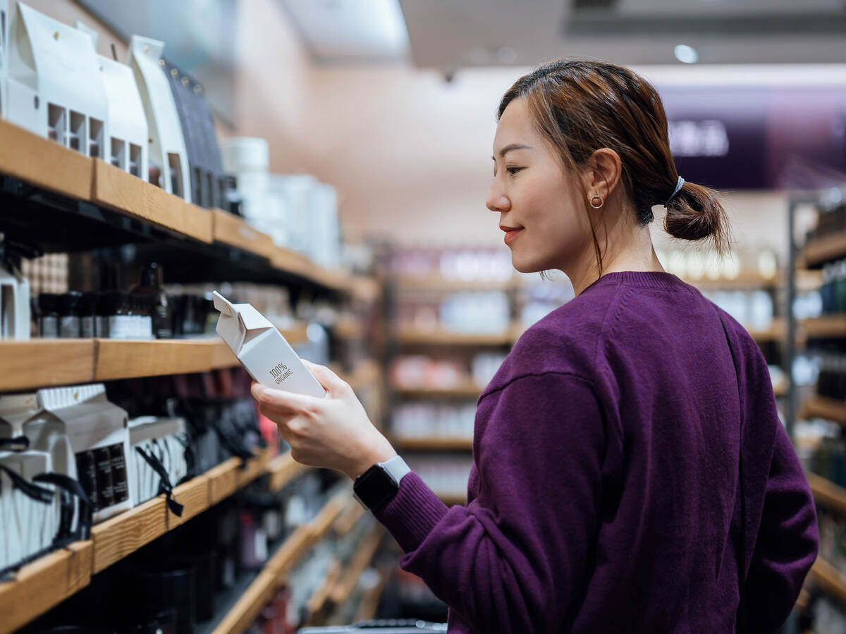 A person looking at the ingredients of the skincare package