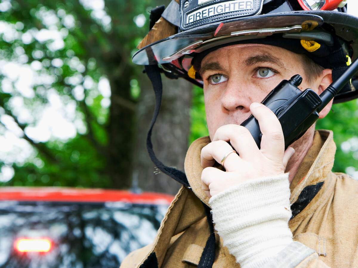 Firefighter talking on a radio